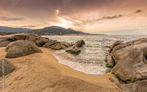 Rocks and sand at Algajola beach in Corsica