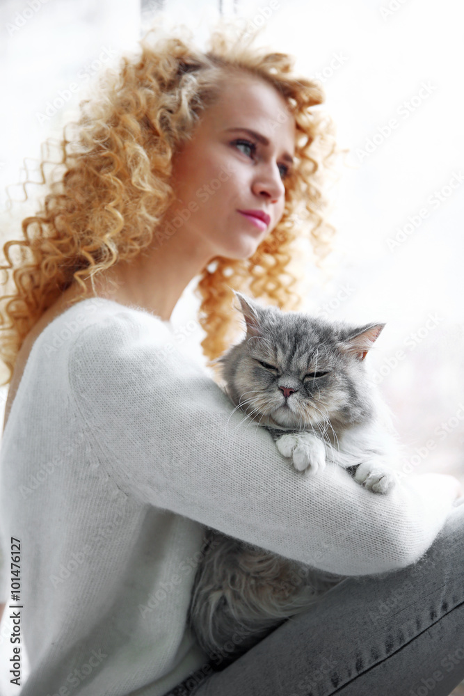 Young woman and cat in the room Young woman and cat in the room