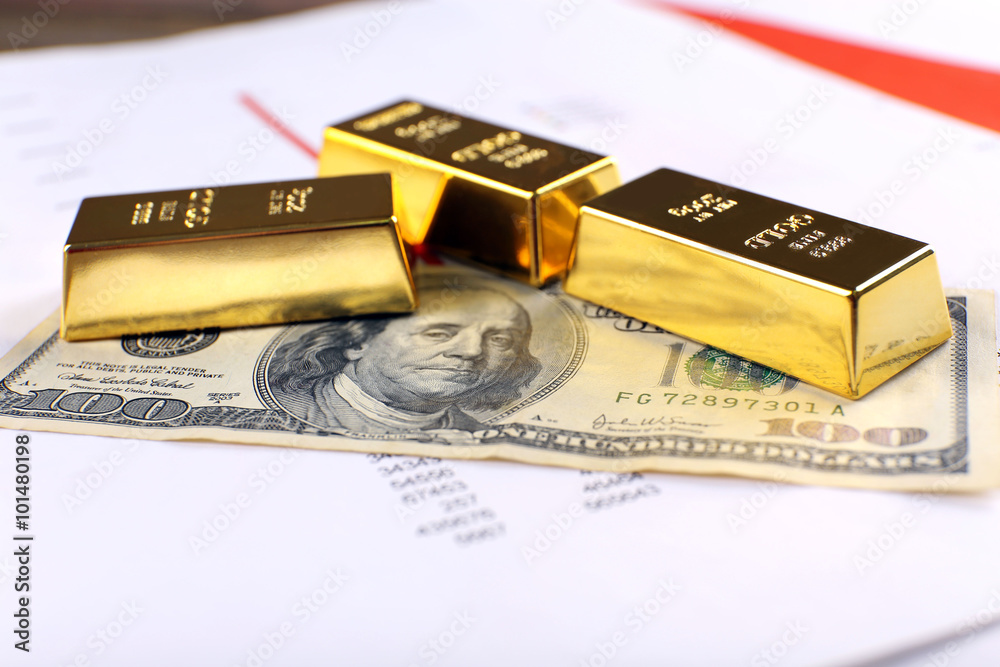 Gold bars with dollar banknote on paper background Gold bars with dollar banknote on paper background