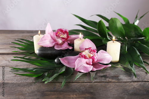 Spa still life with beautiful flower and candlelight on wooden table closeup © Africa Studio