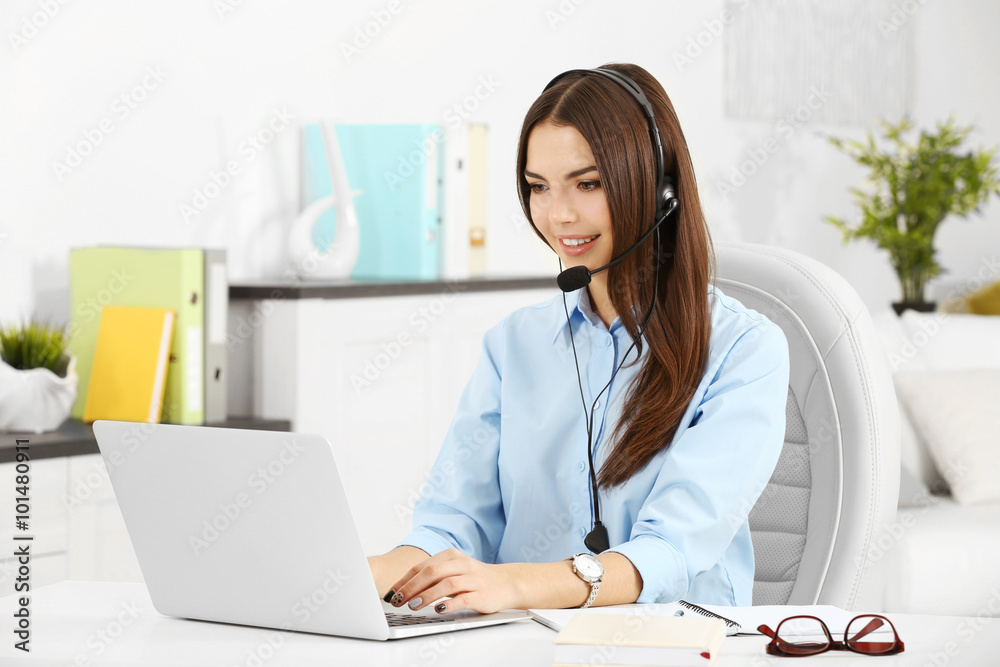 A beautiful woman with headphones and microphone working at the office A beautiful woman with headphones and microphone working at the office