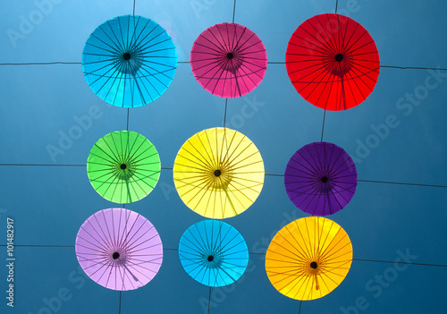 Colorful umbrella hanging on the sky.