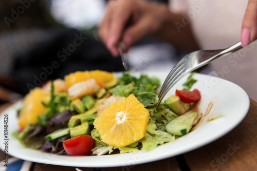 woman is eating a salad