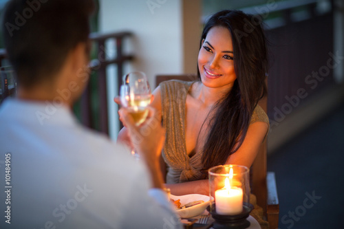 young couple with a romantic dinner with candles Fototapete