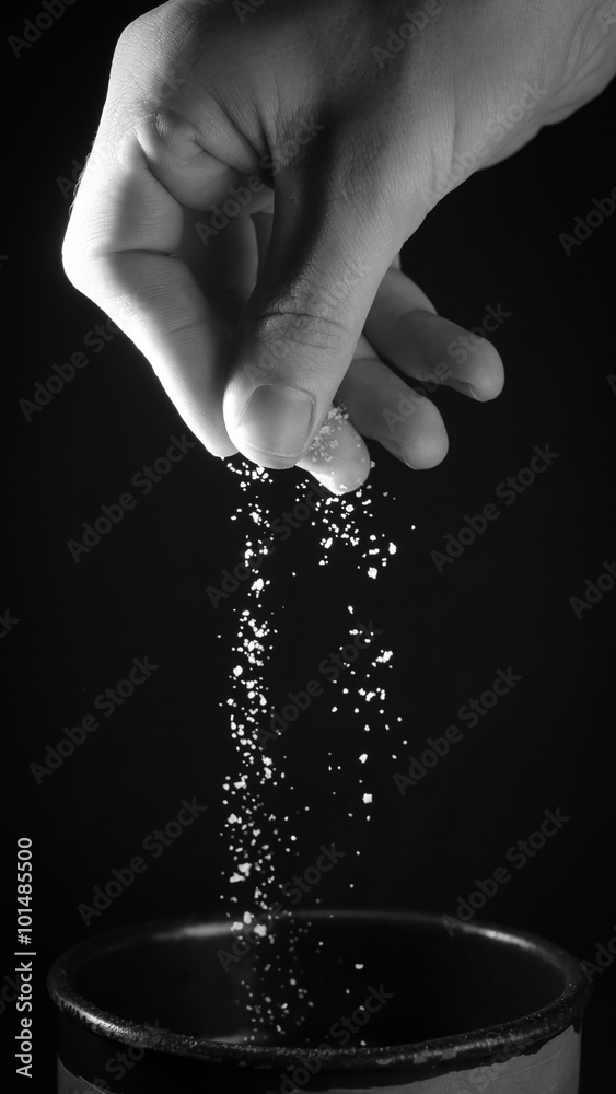 Hand spilling pinch of salt Stock Photo | Adobe Stock