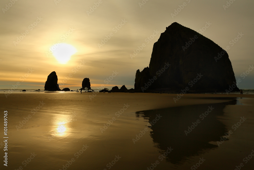 Sunset, Haystack Rock, Oregon, USA. Haystack Rock and rock pinnacles on Cannon Beach at sunset. Oregon, United States.
