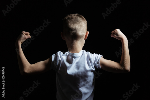 Cuadro en lienzo Silhouette of a Boy Showing Arm Muscles Strength