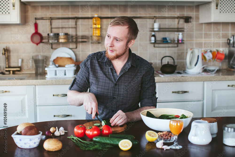 bearded man preparing vegetarian salad in the kitchen bearded man preparing vegetarian salad in the kitchen