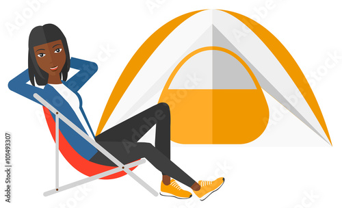 Woman sitting in folding chair.