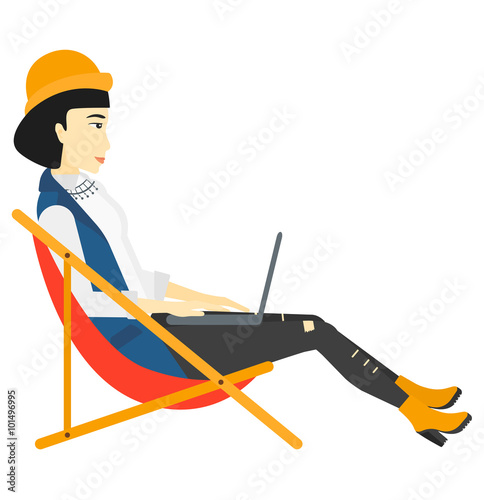 Business woman sitting in chaise lounge with laptop. Fototapeta