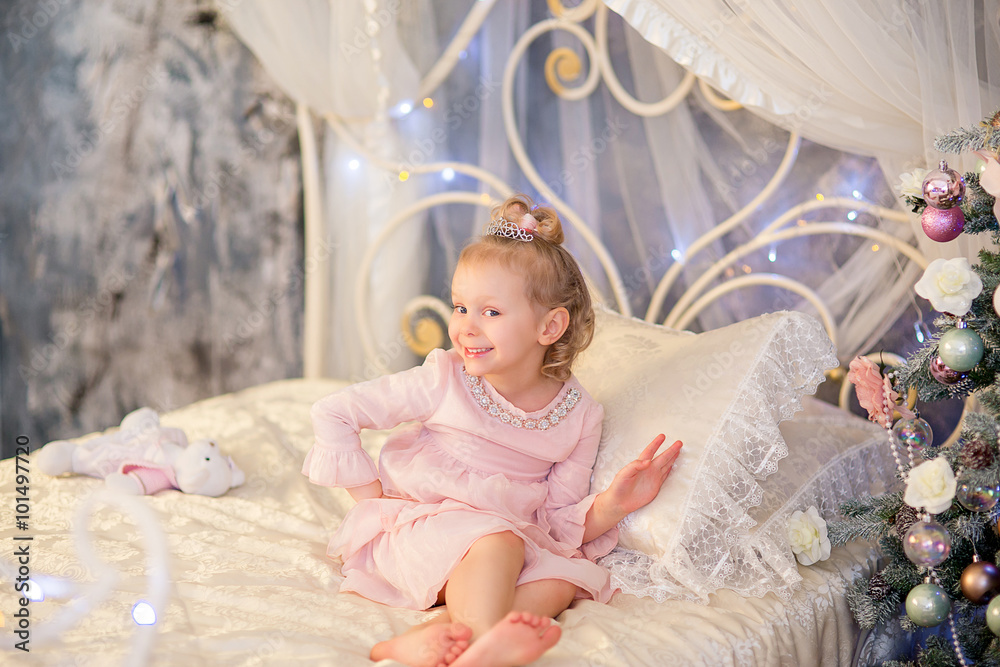 Fototapeta premium the little girl near a Christmas fir-tree