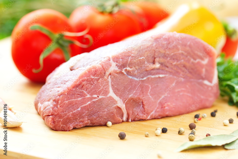 Raw meat with fresh vegetables and spices prepared for cooking
