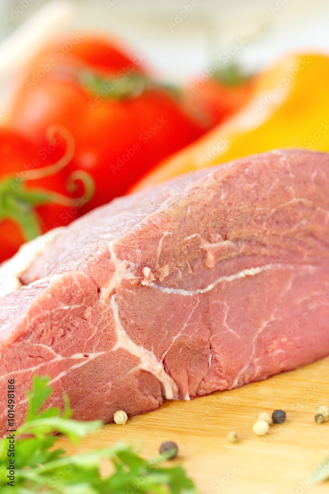 Raw meat with fresh vegetables and spices prepared for cooking Raw meat with fresh vegetables and spices prepared for cooking