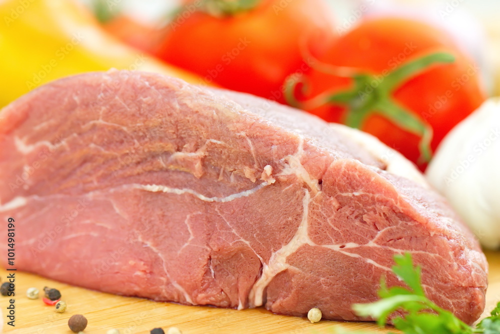 Raw meat with fresh vegetables and spices prepared for cooking Raw meat with fresh vegetables and spices prepared for cooking