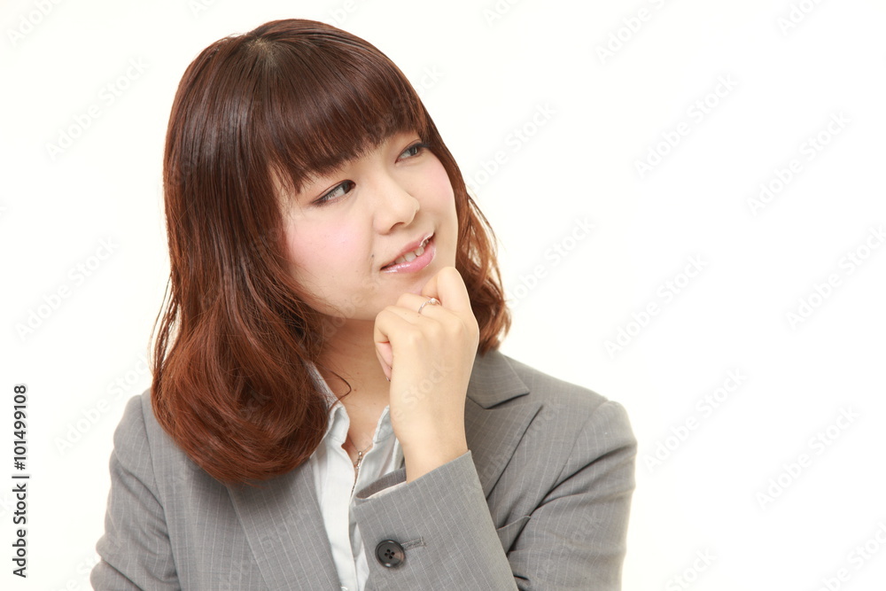 young Japanese businesswoman thinks about something young Japanese businesswoman thinks about something