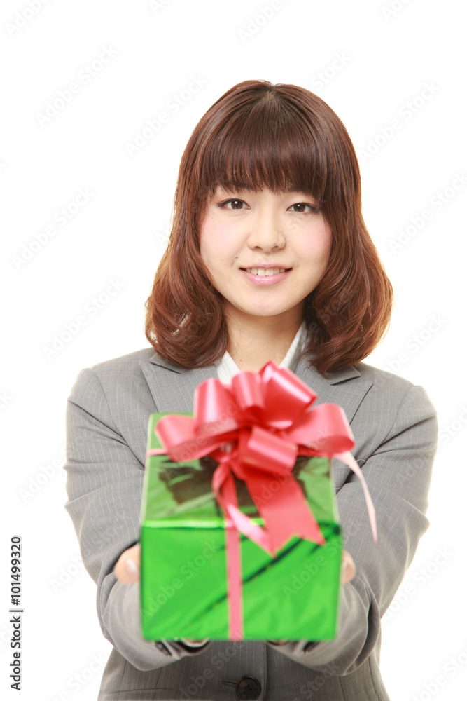 young Japanese businesswoman offering a gift young Japanese businesswoman offering a gift