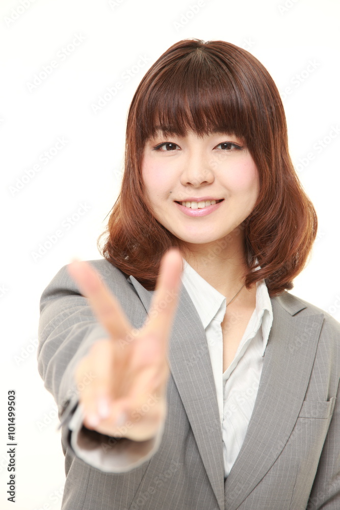 young Japanese Businesswoman showing a victory sign young Japanese Businesswoman showing a victory sign