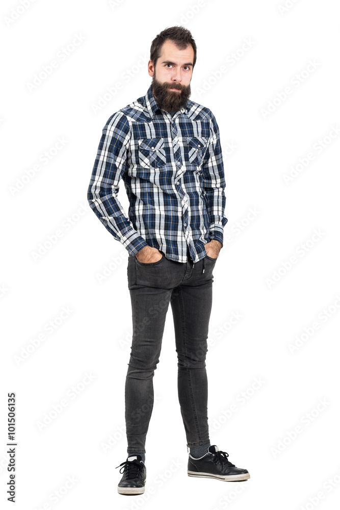 Funny skeptical expression of bearded hipster with hands in pockets looking at camera. Full body length portrait isolated over white studio background. Funny skeptical expression of bearded hipster with hands in pockets looking at camera. Full body length portrait isolated over white studio background.
