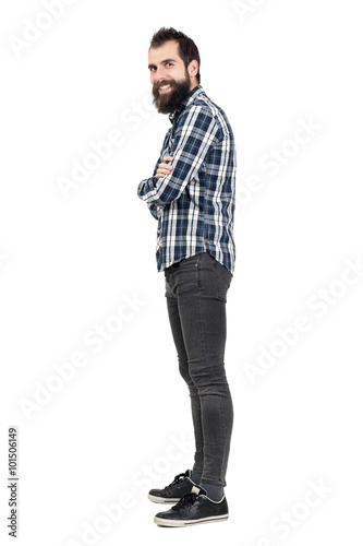 Side view of funny laughing hipster with smiley piercing in upper lips looking at camera. Full body length portrait isolated over white studio background.