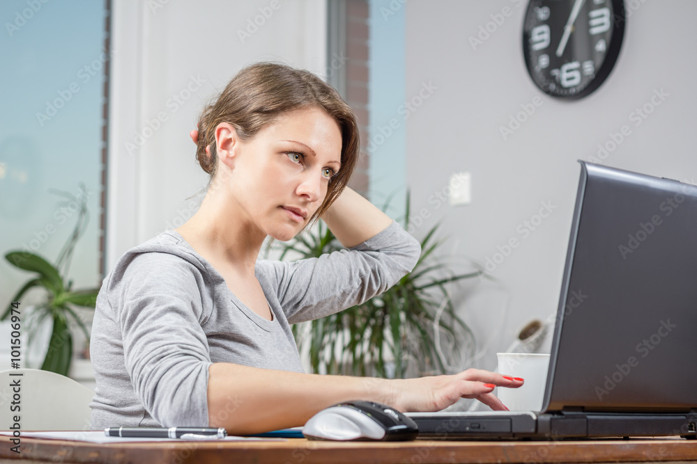 Photo of young woman working at home office Photo of young woman working at home office