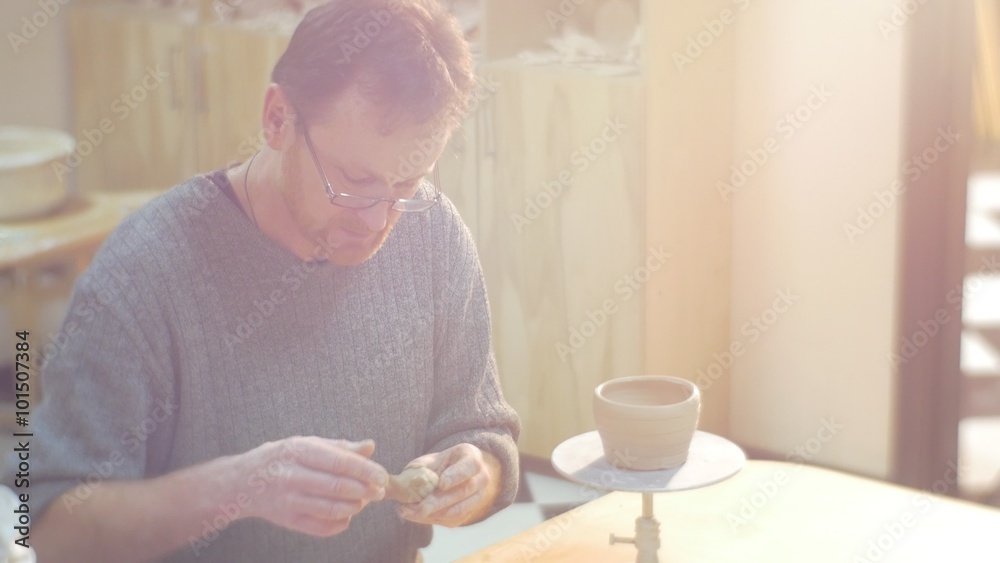 Man is Sculpting a Cat Statuette Clay Pot Placed to a Table Girl Kid Sitting Close to Man Little Blonde Girl Daughter Granddaughter Man in Glasses Man is Sculpting a Cat Statuette Clay Pot Placed to a Table Girl Kid Sitting Close to Man Little Blonde Girl Daughter Granddaughter Man in Glasses