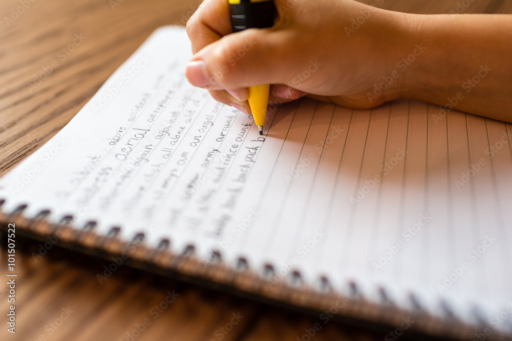 Canvas Print Child writing by hand on notepad