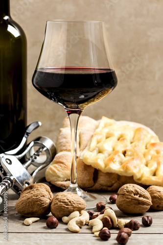 red wine glass with focaccia, hazelnut, cashew and walnut