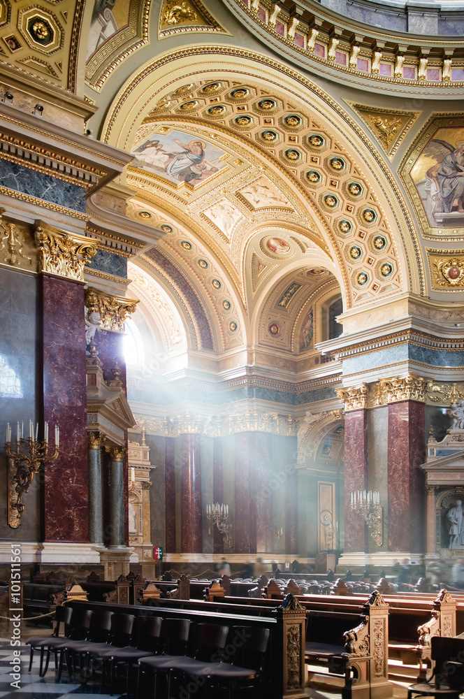 Inside view of St. Stephen's Basilica in Budapest lightened by dramatic sunshine.