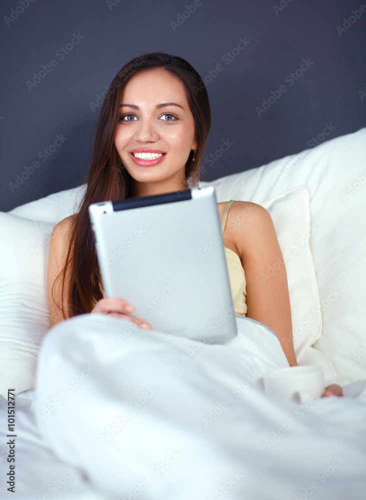 Women use a tablet pc on the bed Women use a tablet pc on the bed