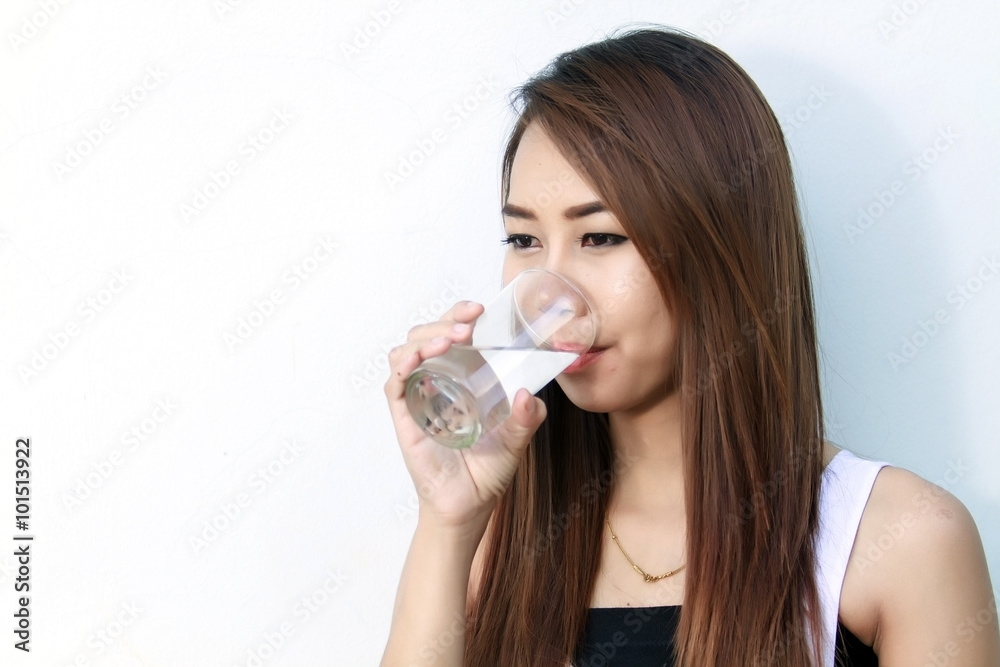 Portrait of young beautiful woman asia drinking water at summer and holding bottle Portrait of young beautiful woman asia drinking water at summer and holding bottle