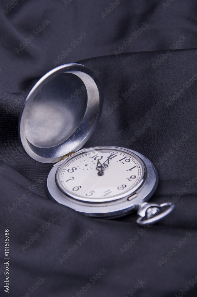 Fotografie Pocket watch on black silk