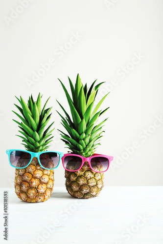 Ripe pineapples on a white wooden table