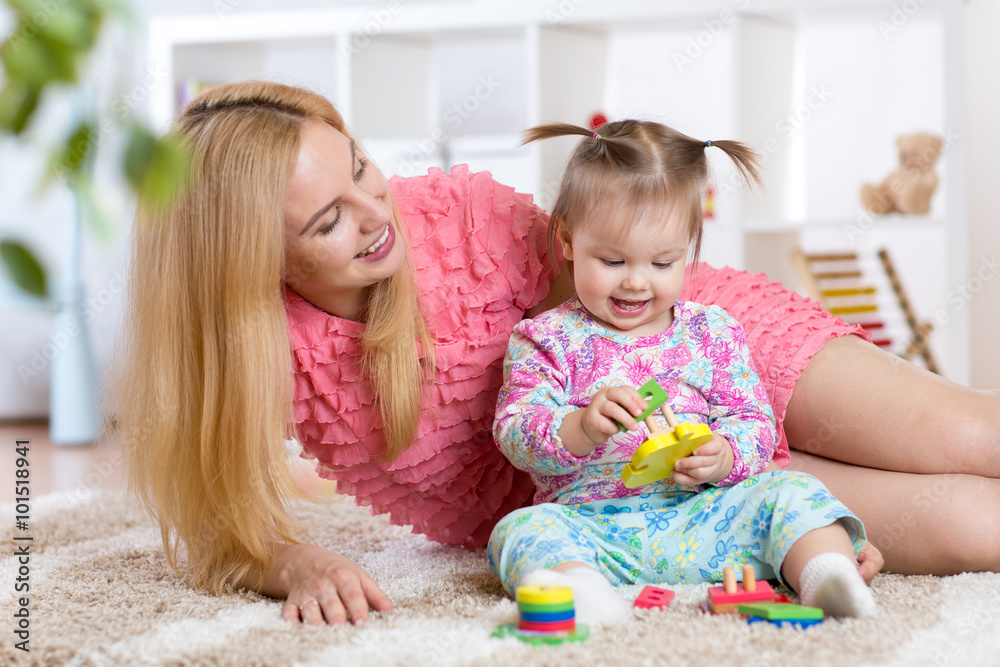 mother and her child playing with colorful puzzle toy mother and her child playing with colorful puzzle toy
