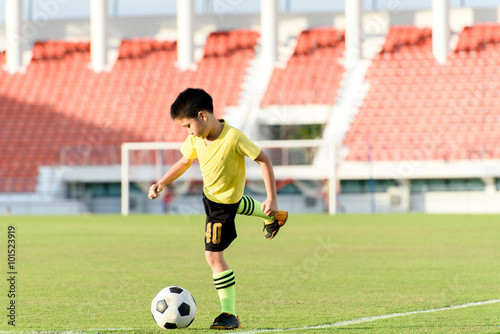 Boy and football in the football grass field © TinPong