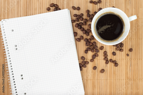 Empty exercise book with coffee