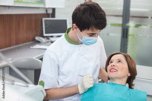 Professional male dental doctor is making treatment