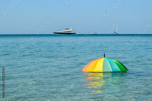 colorful umbrella on sea water background © aon_skynotlimit
