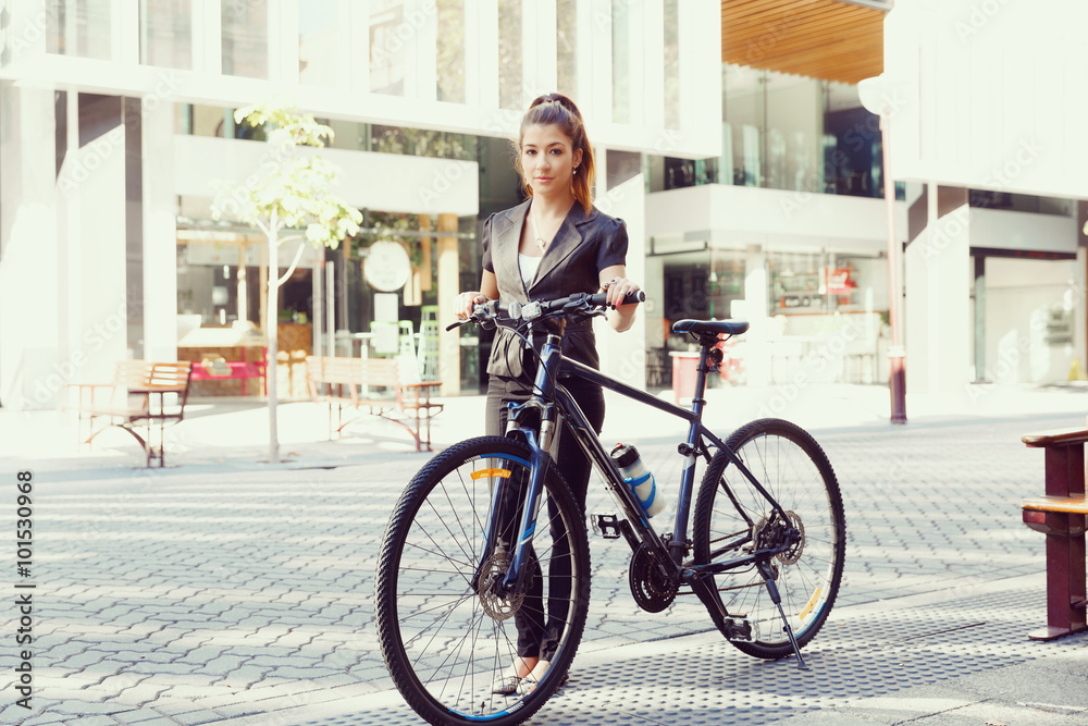 Fototapeta premium Young woman commuting on bicycle