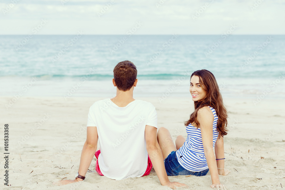 Romantic young couple sitting on the beach