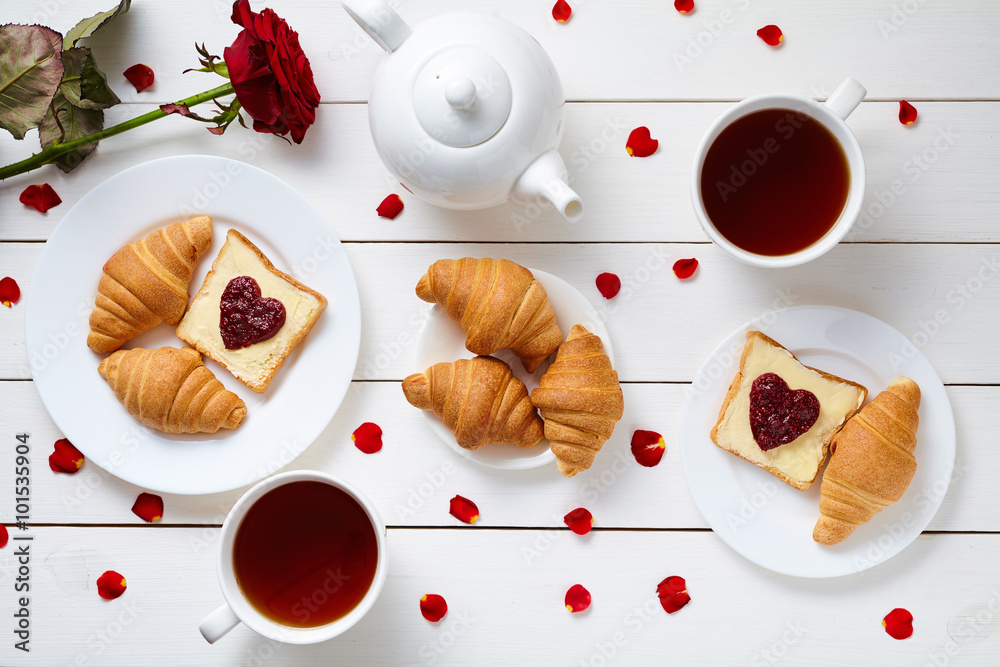 Φωτογραφία Breakfast for couple on Valentines Day with toasts, heart shaped jam, croissants