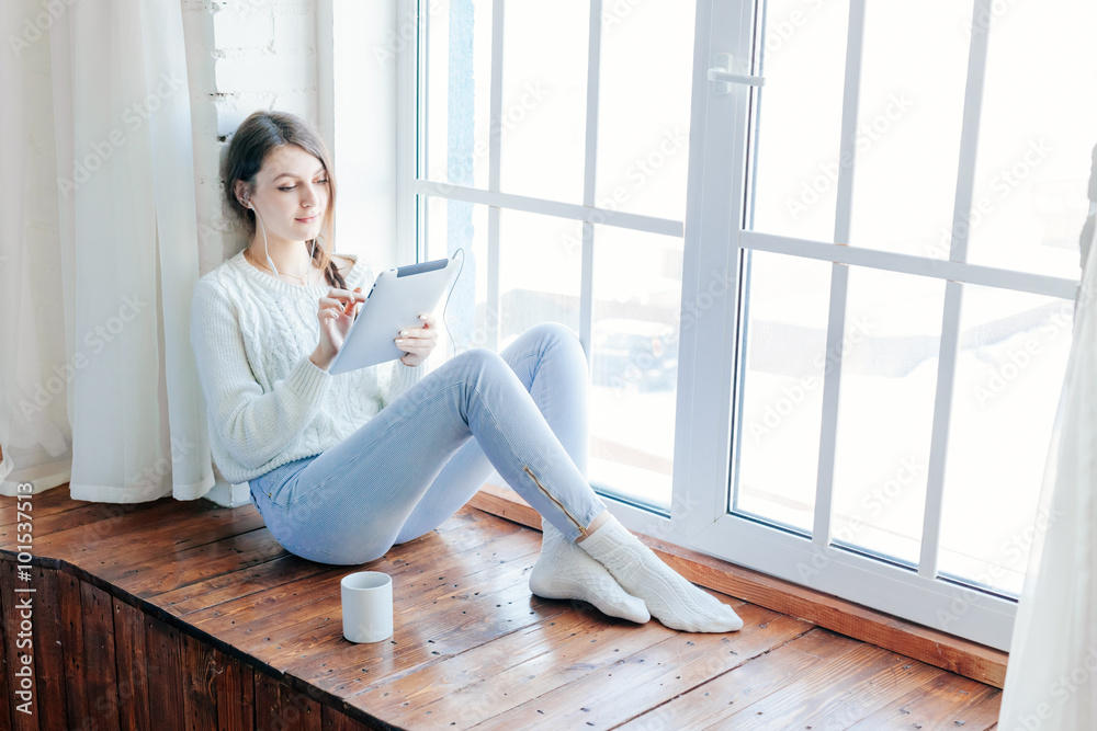 woman smiling. she reads an sms on her mobile phone 