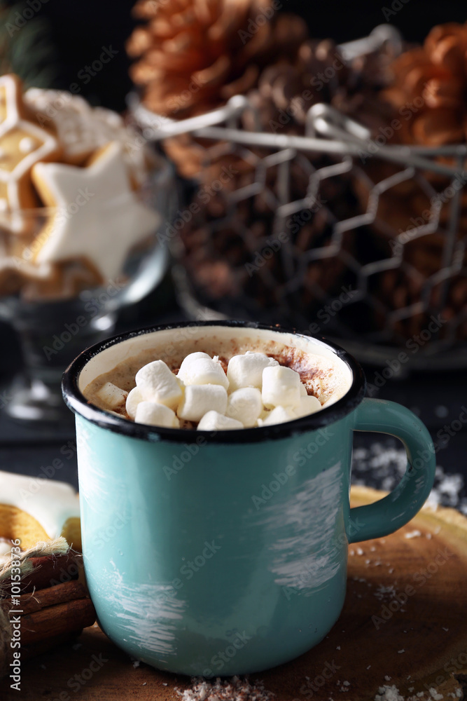 Mug of hot cacao with marshmallow and cookies on black table Mug of hot cacao with marshmallow and cookies on black table