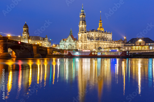 Dresden Cathedral of the Holy Trinity aka Hofkirche Kathedrale Sanctissima Trinitatis and Augustus Bridge with reflections in the river Elbe at night in Dresden  Saxony  Germany