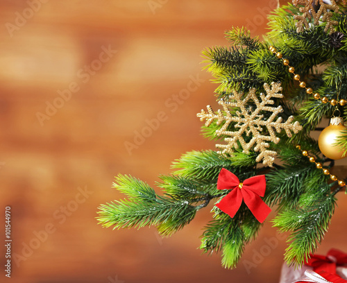 A handmade green Christmas tree on wooden wall background  close-up