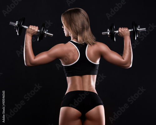 Sexy fitness girl with dumbbells