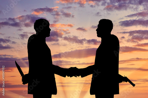 Fototapeta Silhouette of two businessmen shaking hands