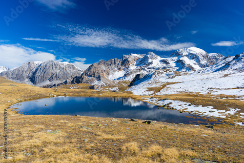 High altitude blue alpine lake in autumn season