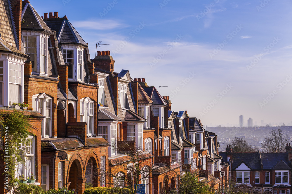 London, United Kingdom - Traditional British brick houses at Muswell Hill on a panoramic shot early in the morning with blue sky
