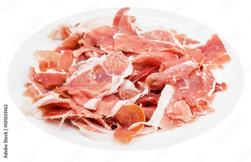 many slices of dry-cured ham on plate isolated
