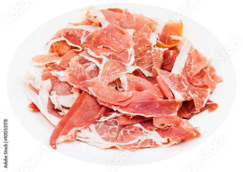 thin sliced uncooked jerked pork on plate isolated